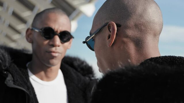 Portrait of two black brother twins wearing sunglasses - African American trendy music band 