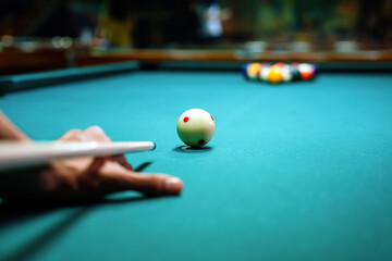 Preparing to break spheres into the pool pocket. People billiard, snooker entertainment concept.