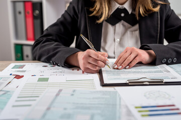 closeup woman filling 1040 tax form at office