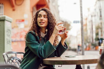 Woman tourist drinking traditional Turkish tea in outdoor cafe