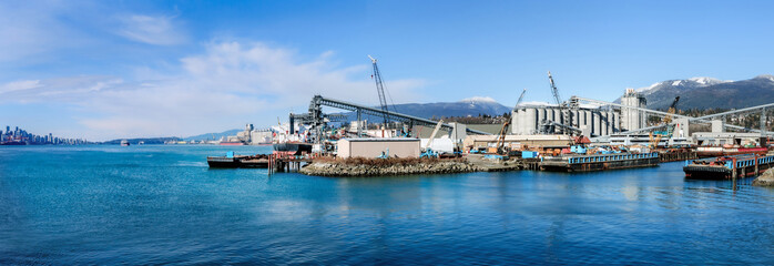 Harbor port industry with view of downtown cityscape on sunny day. Panorama of marine industry,...