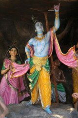 Grotto with statues depicting the life of Krishna in the courtyard of a Vrindavan temple. India.