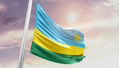 Waving Flag of Rwanda in Blue Sky. The symbol of the state on wavy cotton fabric.