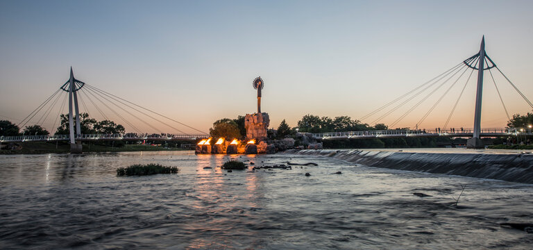 The Keeper of the Plains and footbridges on Arkansas River at sunset, Wichita, Kansas, USA
