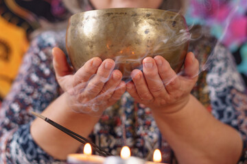 woman holding a Tibetan singing bowl