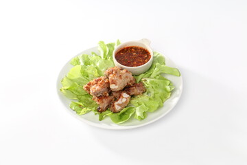 ribs sliced on a white plate with a green salad
