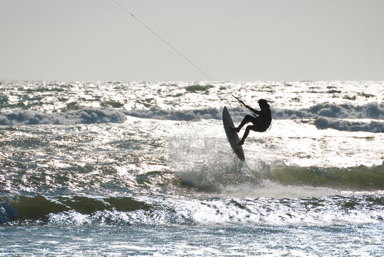 Silhouette of kite surfer enjoying a sunny winter day in Rhode Island