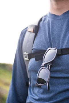 Sunglasses hanging from sternum strap of man, Marin County, California, USA