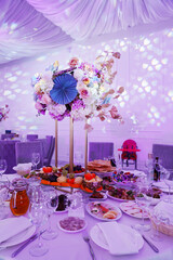 decoration of the served table with a bouquet on a stand
