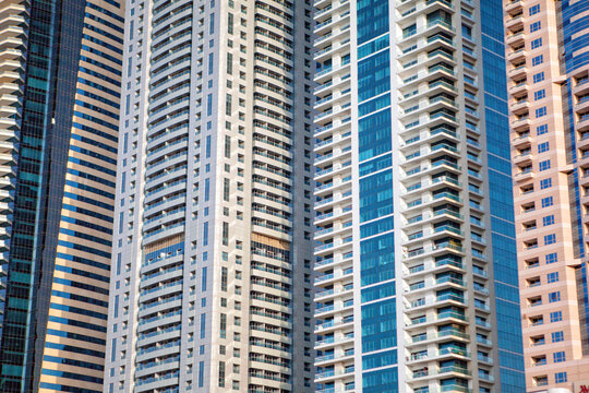 Windows and balconies of tall skyscrapers standing in row, Dubai, United Arab Emirates