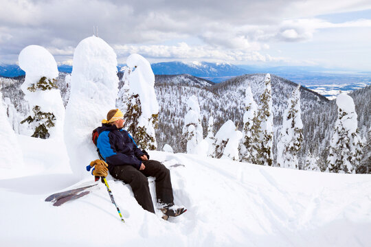 A Male Backcountry Skier Takes A Break After Skinning Up A Ridge In The Whitefish Range Near Whitefish, Montana