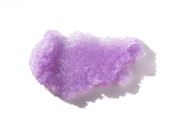 Purple sugar body scrub texture on white background. Cosmetic smear. Appearance of the texture of the lilac swatch. Natural skincare products. Beauty concept for face and body care.