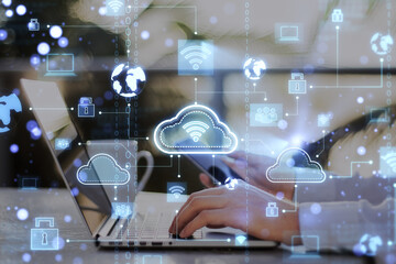 Modern technologies and cloud computing connection concept with digital light cloud icons with wi-fi symbol inside surrounded by social signs on man hands using laptop background, double exposure
