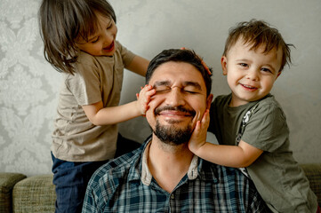 Kids playing with father at home