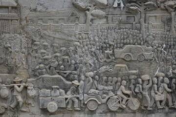Memorial shrine festooned with bas-reliefs of Khmer Rouge atrocities at Wat Somrong Knong. Cambodia.