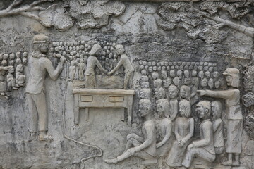 Memorial shrine festooned with bas-reliefs of Khmer Rouge atrocities at Wat Somrong Knong. Cambodia.