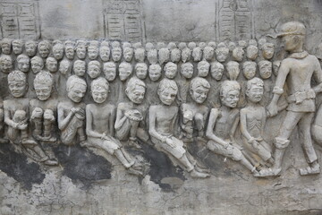 Memorial shrine festooned with bas-reliefs of Khmer Rouge atrocities at Wat Somrong Knong. Cambodia.