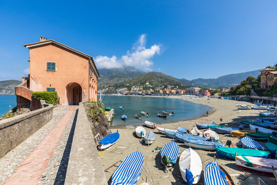 Italy, Liguria, Levanto, Villa Preia and rowboats lying on Spiaggia Levanto beach
