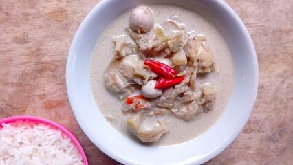 Sayur nangka is Indonesia vegetable soup made from young jackfruit, coconut milk. served in a bowl on a wooden table