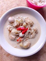 Sayur nangka is Indonesia vegetable soup made from young jackfruit, coconut milk. served in a bowl on a wooden table
