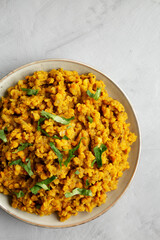 Homemade Red Lentil Dahl with Rice and Cilantro on a gray background, top view. Flat lay, overhead, from above. Copy space.