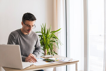 Businessman analyzing graphs at desk in office