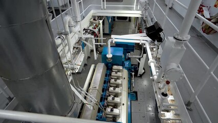 Main engine of vessel and exhaust pipe. Engine room inside