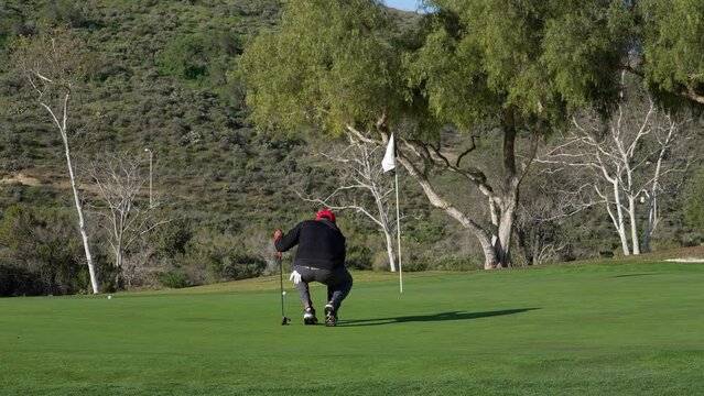 Golfer Lining Up A Putt