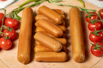 Beef sausage. Raw grilled sausages on a wood flipchart. Deli products.
