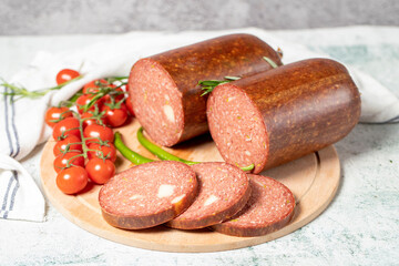 Beef sausage with cheddar. Raw grilled sausage on a wood serving board. Deli products