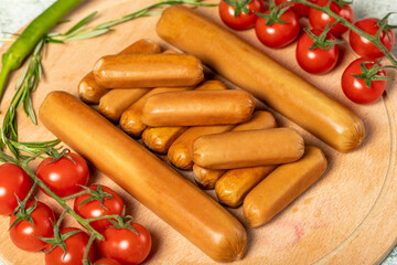 Beef sausage. Raw grilled sausages on a wood flipchart. Deli products.