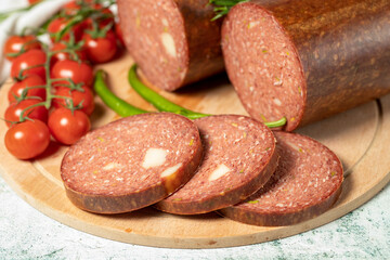 Beef sausage with cheddar. Raw grilled sausage on a wood serving board. Deli products. Close up