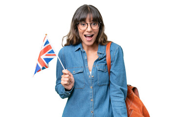 Young caucasian woman holding an United Kingdom flag over isolated background with surprise facial expression - obrazy, fototapety, plakaty