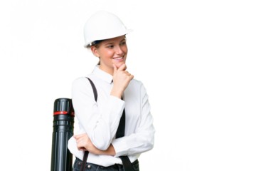 Young architect caucasian woman with helmet and holding blueprints over isolated background looking to the side