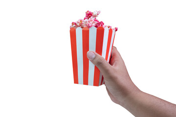 selective focus on the hand holding a pop corn box, red pop corn with strawberry caramel flavor, soft focus