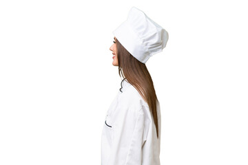 Young chef caucasian woman over isolated background laughing in lateral position