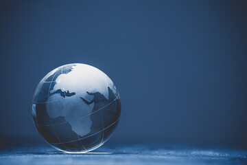 Blue world globe crystal glass on black background	