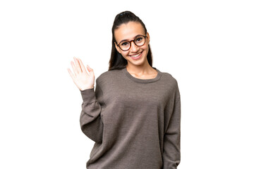 Young Arabian woman over isolated chroma key background saluting with hand with happy expression