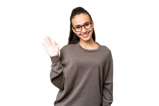 Young Arabian woman over isolated chroma key background saluting with hand with happy expression
