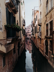 Narrow water canal in the city of Venice, Italy.