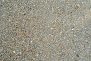 Background with old dusty asphalt interspersed with stone. The road from the asphalt-concrete mixture.