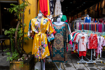 Fototapeta na wymiar Colorful Vietnamese traditional dress for women and kids for sale in Hoi An, Vietnam