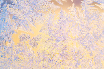 Frosty frost on a glass window. Close-up of ice patterns lightly blurred in soft focus.