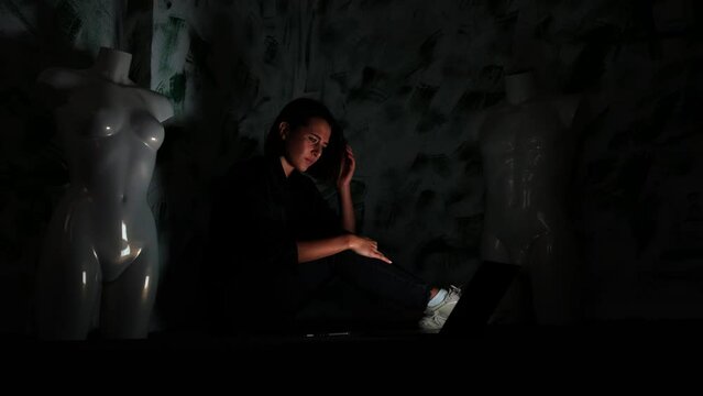Young Suicidal Woman in Dark Corner of Room, Depressed After Reading Hate Messages Taking Knife Above Hand