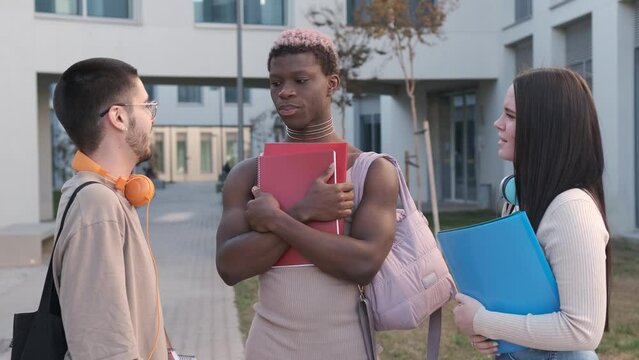 Transgender black student speaking with classmates