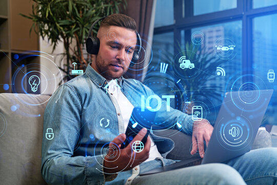 Young man with phone and IOT icons, smart devices and connectivity