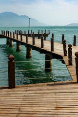 View of the wooden pier with the blue skyline in the background, Ilhabela, São Paulo