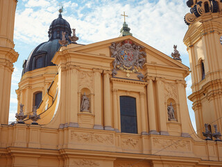 Obraz premium baroque Catholic church with a striking yellow fasade and white stucco interiors. Theatinerkirche, Munich, Germany