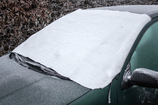 
The car is covered with a sheet from frost