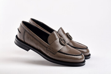 Women's leather khaki moccasins  on white, background, Floating, levitating shoes.